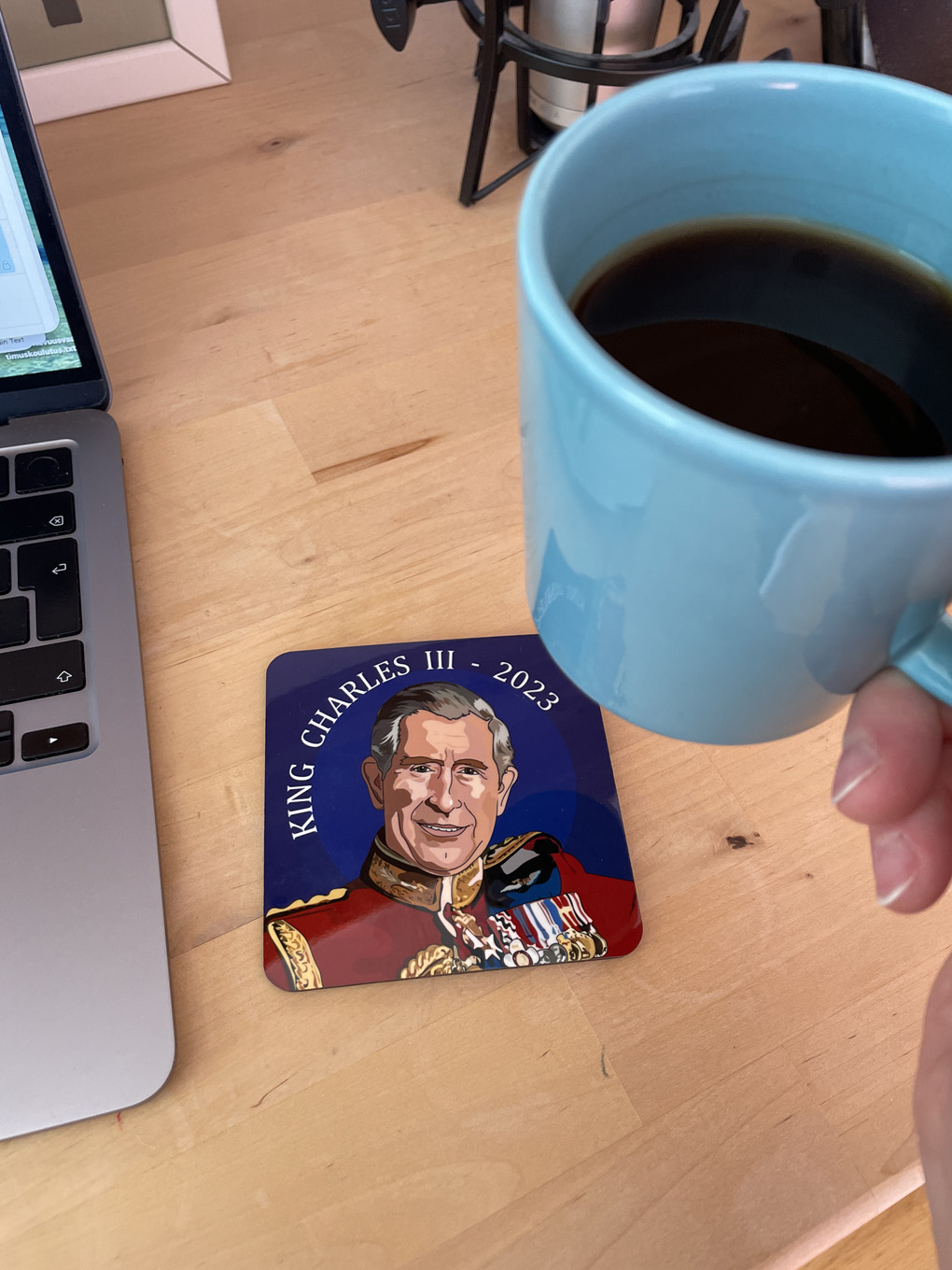 King Charles coasted and a coffee mug held up.