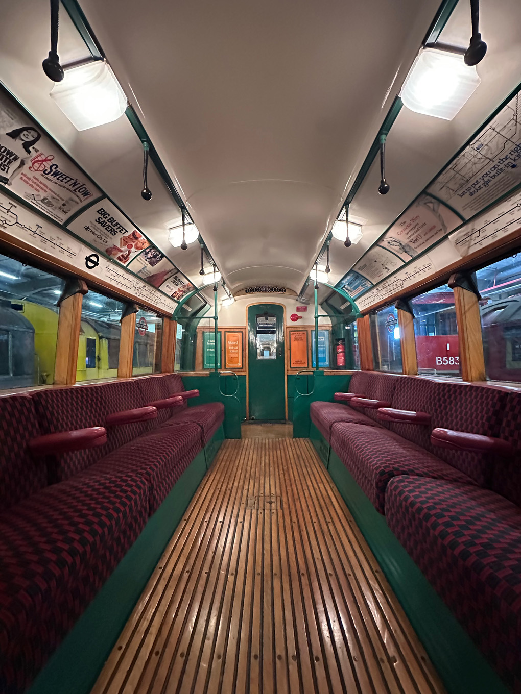 A 1938 rolling stock tube train with wooden floors, green and white paint and red moquette seats.