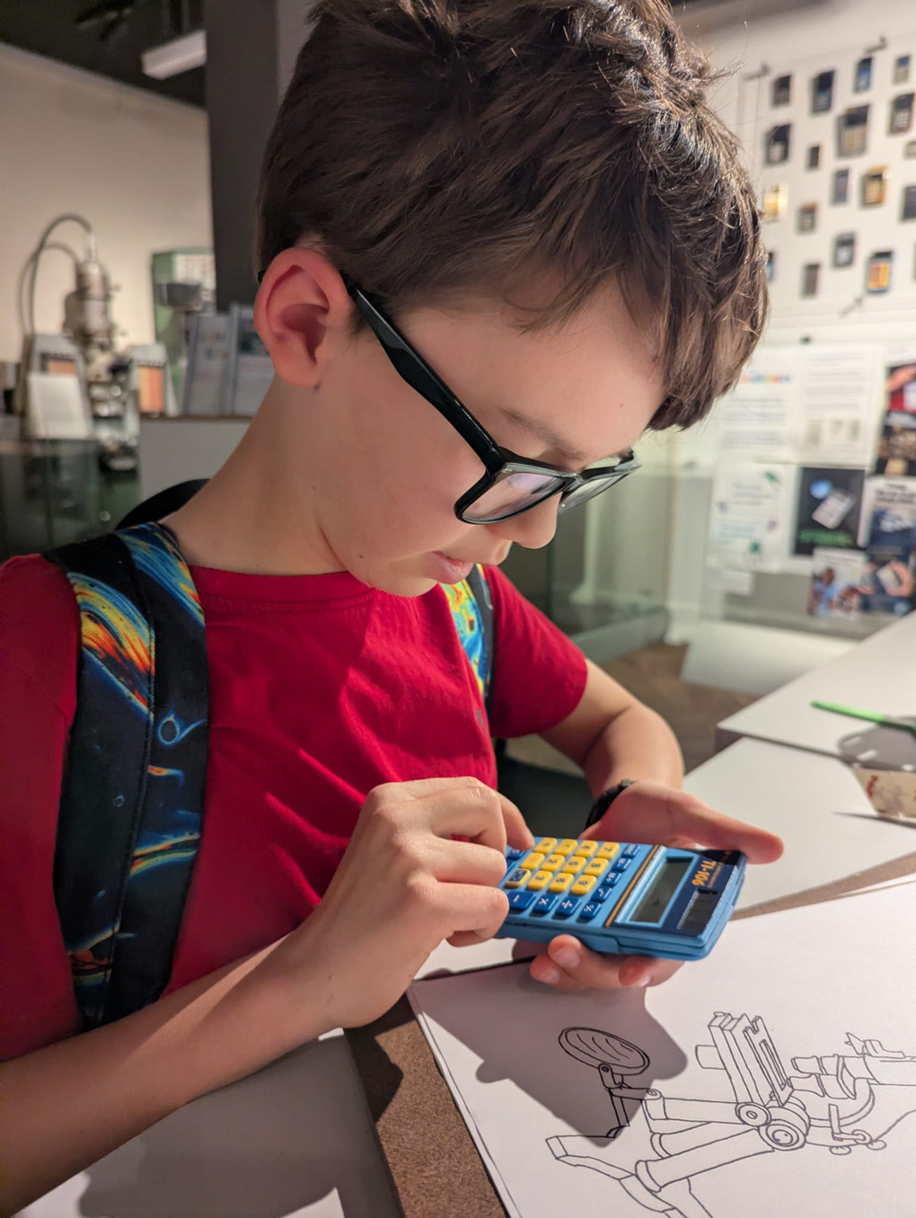 Boy using a small calculator