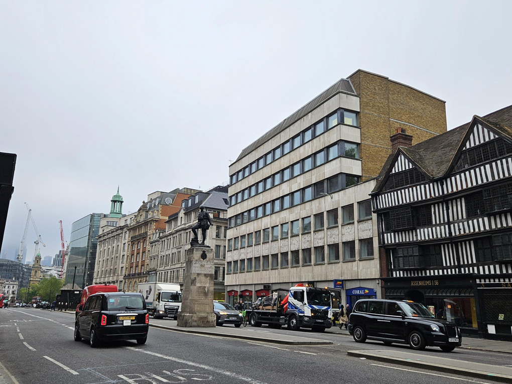 Busy road with buildings ranging from tudor to modern architecture