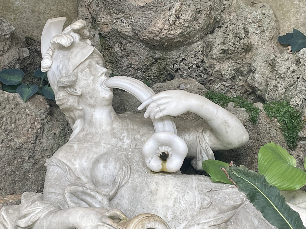 A zoomed in portion of a phallic stone water fountain