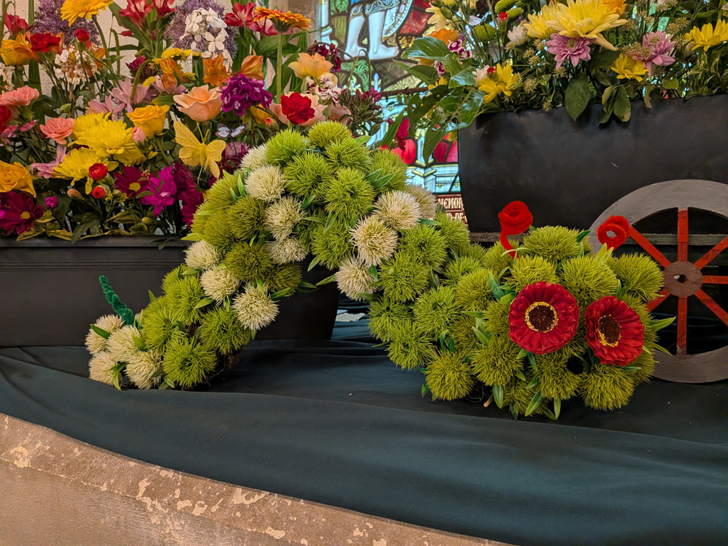 A Large, Green Catapiller, made from fresh flowers.