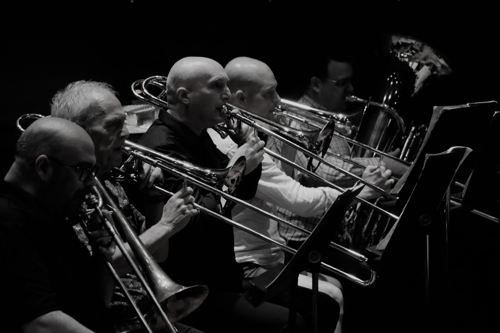 trombones and tuba players in a row