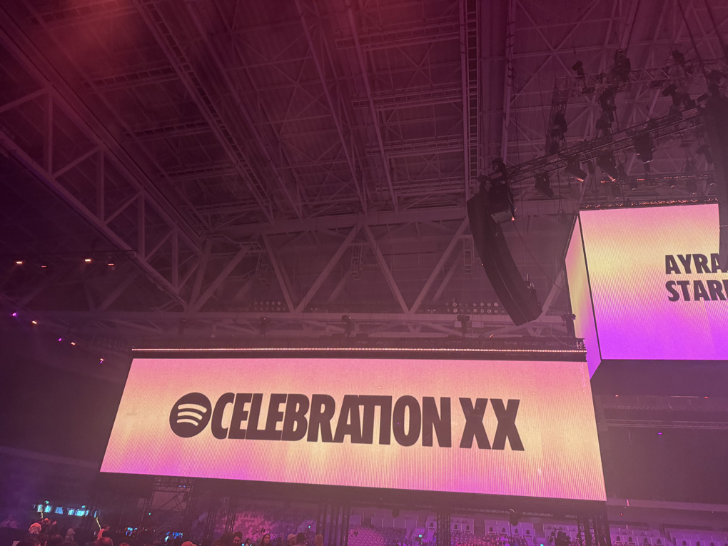 Big LED screen in a stadium with the words celebration XX on it
