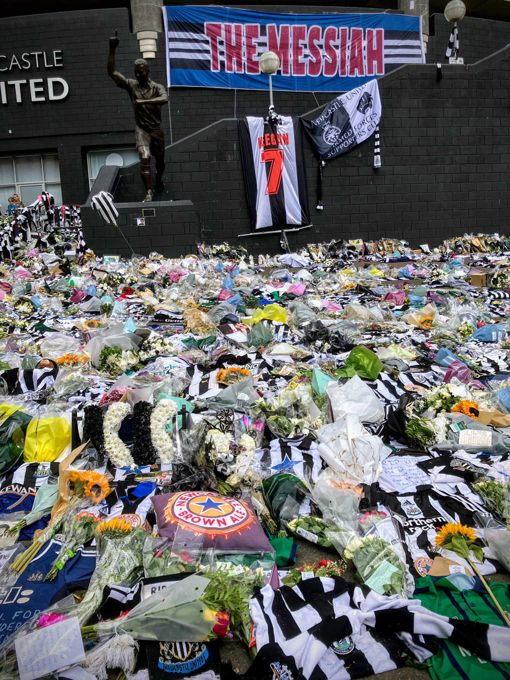 Thousands of flowers, shirts, scarves, and messages cover the ground outside St James’ Park as fans pay tribute to Kevin Keegan.