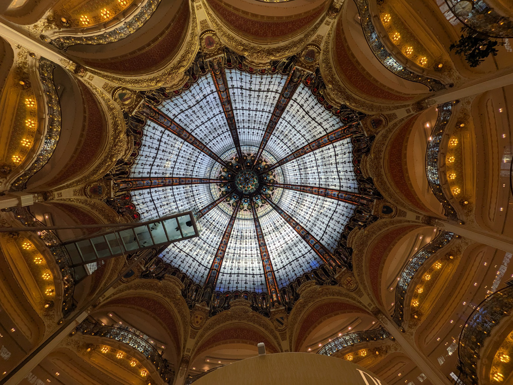Looking up at a domed ceiling in a large department store