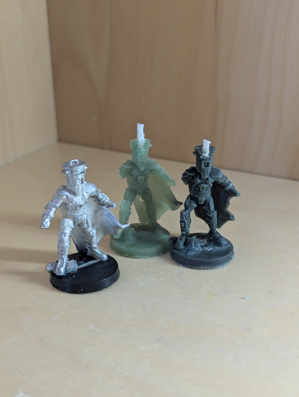 Miniature of Count Binface with two attempts at making a candle from him.