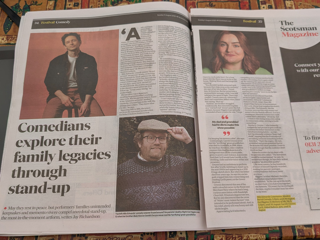 A newspaper opened on a double-page article headlined 