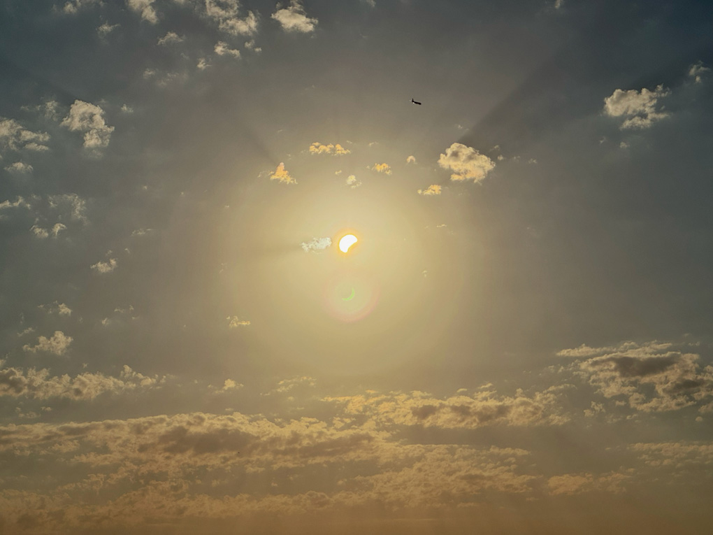 A partial occlusion of the late afternoon sun, with the shadow of the moon obscuring the lower-right portion of the sun