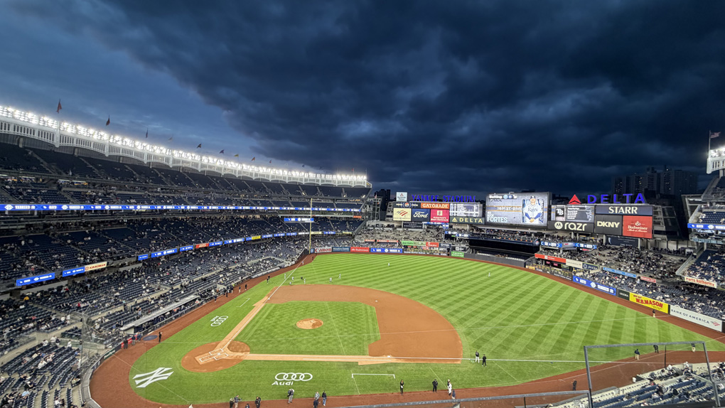 Yankee stadium at dusk with dark clouds on the horizon