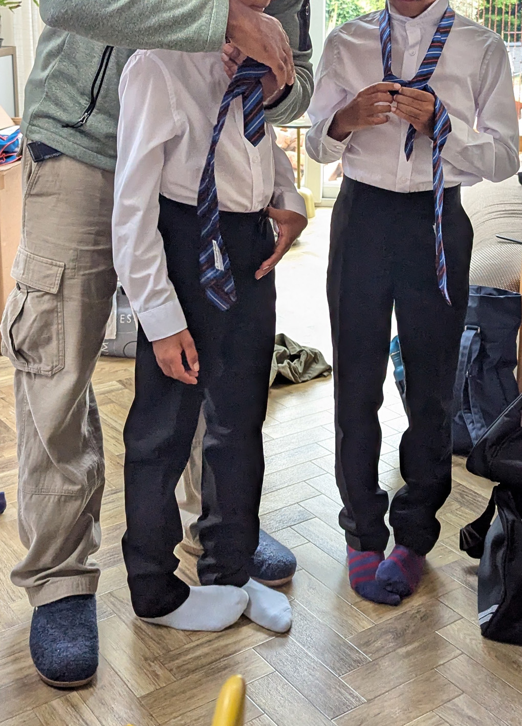 Boys learning how to tie a tie