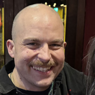 Three people celebrating at the pub