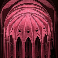 St John's Cathedral lit by candles with small orchestra silhouetted at end.