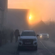 The winter sun cuming over the houses in the distance on a cold and frosty morning in January.