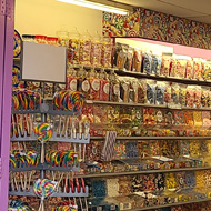 A purple fronted sweet shop with the name Jessica's, lots of sweets everywhere.
