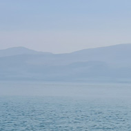 View of Snowdonia mountains across a calm sea