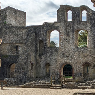 Ruins viewed through a rough stone archway