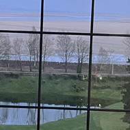 A twilight view of the sands framed by a hotel window