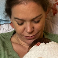 Lady sitting in a chair holding a baby