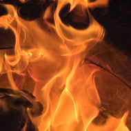 A circular fire pit, with a fire, photo taken from above