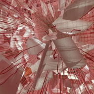 Hundreds of hanging rows of red string hold up different A4 sheets expressing thanks and gratitude to various people around the world (and also the tooth fairy)