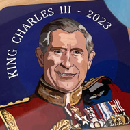 King Charles coasted and a coffee mug held up.