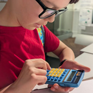 Boy using a small calculator