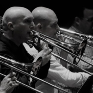 trombones and tuba players in a row