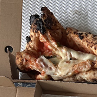 Ruined squashed pizza in a box
