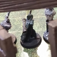 28mm miniatures sit on a laminated map with a plastic wall on the near side of the view