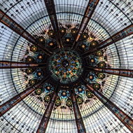 Looking up at a domed ceiling in a large department store