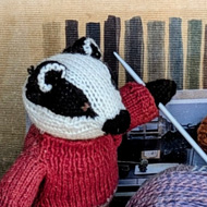 Came across a shop window at one of our favourite towns in the area, depicting a clothes line with miniature knitted clothes of various colours hanging on it. Underneath the line were an array of knitted animals, elephants, badgers, a rabbit and a mouse with a few balls of wool in the foreground. It seemed the badgers were trying to teach the other animals to knit but not knowing how to  start and getting in a fix.  A fun scene  and  a lot of thought and work put into it. The bottom photo is of a lovely antique chair decorated with bee stickers and having a very soft cushion made up of  lots of coloured pompoms sewn together.  The chair was part of a decorated Chair Trail throughout the town.  A great idea!