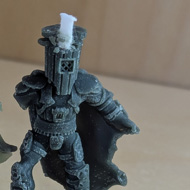 Miniature of Count Binface with two attempts at making a candle from him.