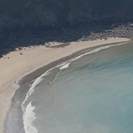 A photo of the sea sand and cliffs at Lee Bay in Devon looking down from the cliff top