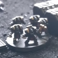 8mm scale miniatures stride across a tiny, unpainted battlefield
