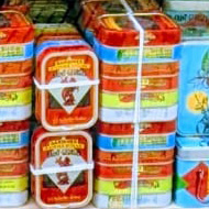 Many different varieties of tinned fish in colourful tins in a French shop