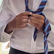 Boys learning how to tie a tie