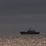 We see a boat framed by a sunrise near Ramsgate