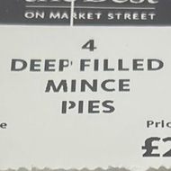 Four mince pies in a box on a store shelf