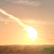 The setting sun, giving the fields in the fire ground orangey hues