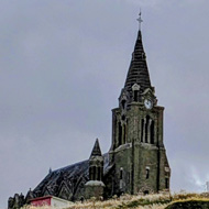 Church and a cross on a hill